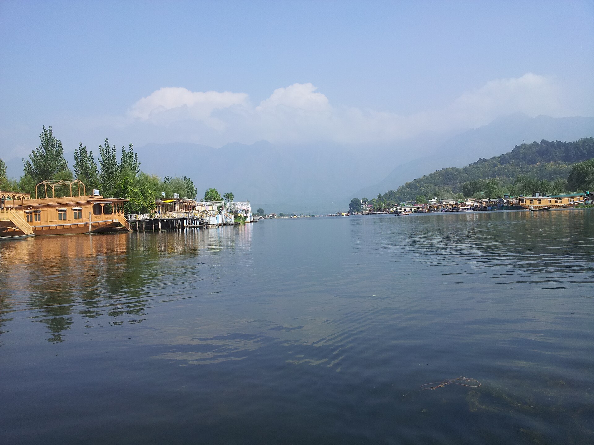 Traditional Kashmiri houseboat on Dal Lake at golden hour